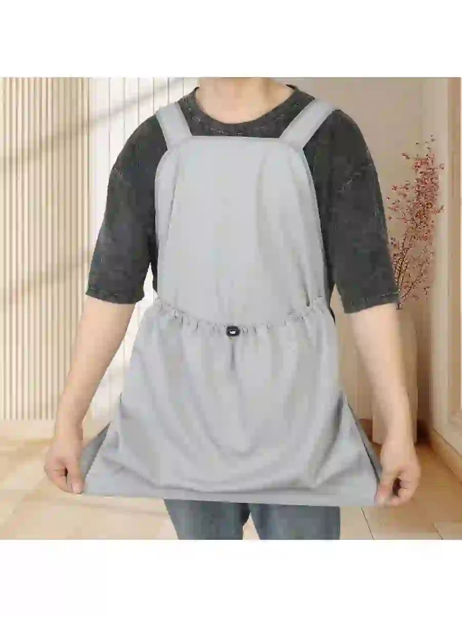 Light gray non-shedding grooming apron for cats and pets, adjustable waist, worn over casual clothing during grooming or bathing