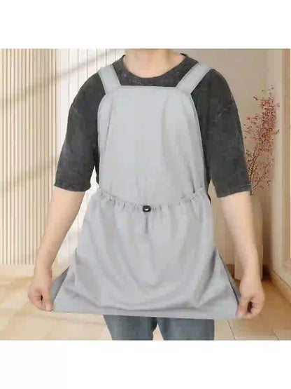 Light gray non-shedding grooming apron for cats and pets, adjustable waist, worn over casual clothing during grooming or bathing