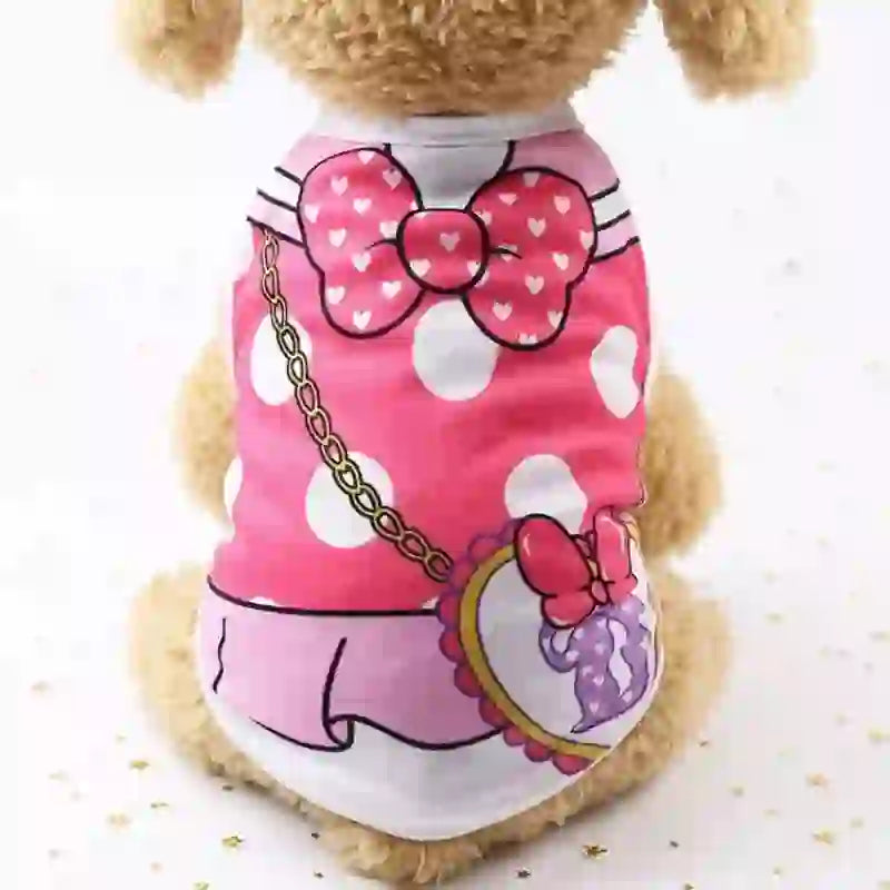 Cute plush dog wearing a pink cartoon vest with white polka dots, bow detail, and a small purse accessory, designed for pet comfort and style