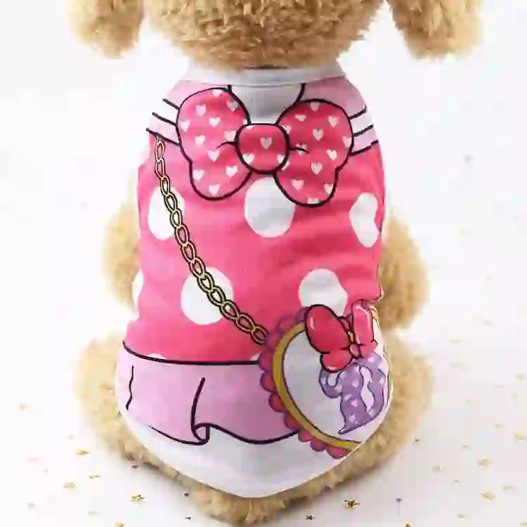 Pet dog wearing a pink cartoon vest with white polka dots, bow design, and a matching pendant, made of soft fabric for comfort