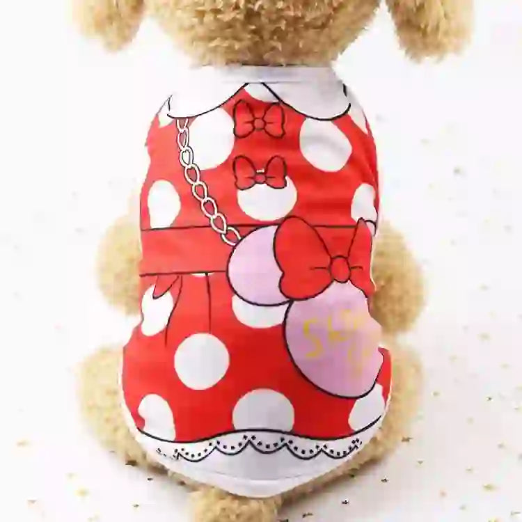 Pet dog wearing a red polka dot cartoon vest with bow accents, featuring a chain design and decorative elements, for comfortable everyday wear